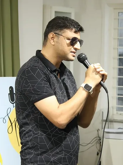 A cool and confident performer at a "Speaking Souls" open mic.