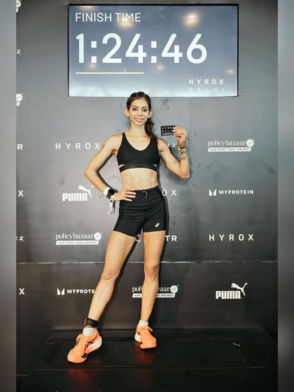 Standing proud with my finish time. This image represents a personal victory and proof that consistent training delivers measurable results. I help athletes achieve their own moments of success.