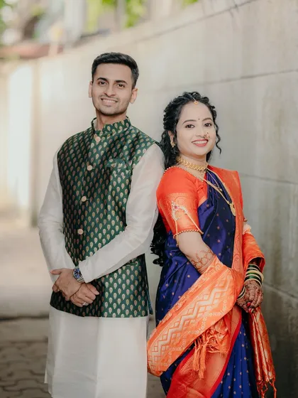 A classic portrait of the newly engaged couple. Their coordinated traditional outfits look stunning, and their happy smiles tell the whole story.