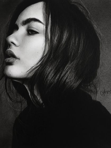 A charcoal portrait of a woman, showcasing soft blending and dramatic lighting. Our courses cover various mediums, including charcoal, to achieve different artistic effects.