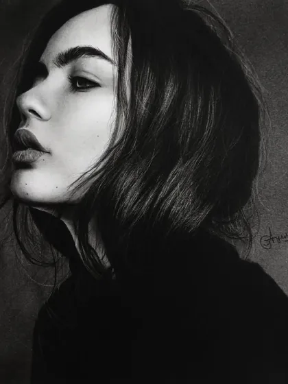 A dramatic and moody portrait in charcoal by Ayush Agnihotri. The deep blacks and subtle highlights create a sense of depth and mystery, demonstrating the expressive power of the medium.