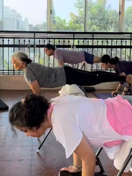 Chair-supported Chaturanga Dandasana builds incredible upper body and core strength. Props make challenging poses like this one more accessible and allow us to hold them with integrity.