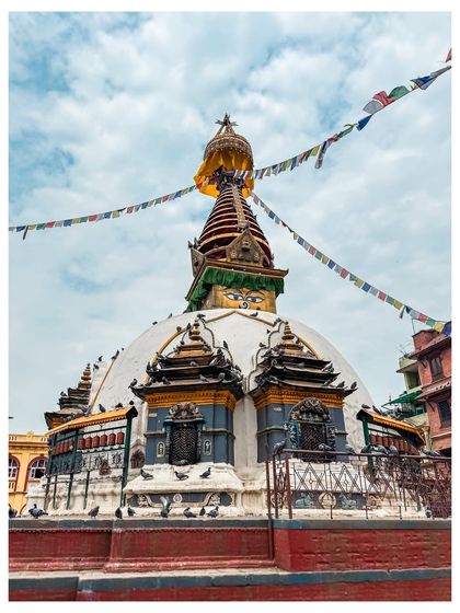 The Kaathe Swayambhu stupa in Kathmandu, with its all-seeing eyes and colorful prayer flags.