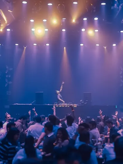 On stage at Illuzion Club Hyderabad, with my hands up, commanding the crowd. The stage setup here is perfect for a high-impact performance.