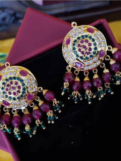 The earrings from the 'रुकमणि' (Rukmani) set. The design mirrors the colourful, circular pattern of the necklace for a complete and coordinated look.