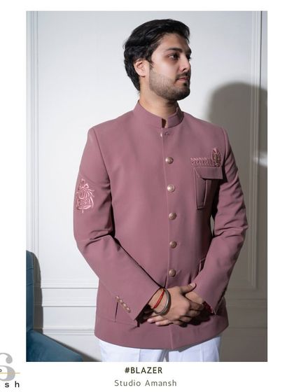 A frontal view of the pink Prince Coat, showing the delicate embroidery on the pocket flap and sleeve. This is a great choice for a daytime wedding or engagement.