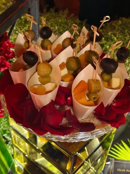 Individual cones of olives and cheese, a convenient and elegant way to serve appetizers during a mingling event.