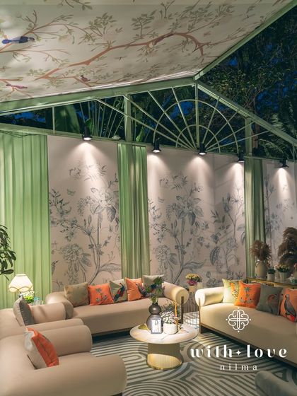 The lounge area of 'The Conservatory' at night, beautifully illuminated to highlight the custom decor.
