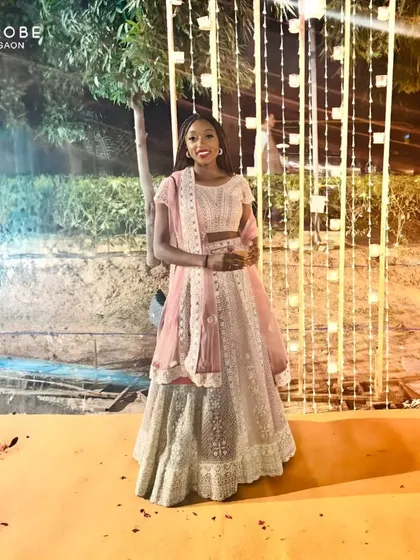This happy renter looks stunning in a pastel pink and silver lehenga. It's a testament to how renting can make you feel special without the expense.
