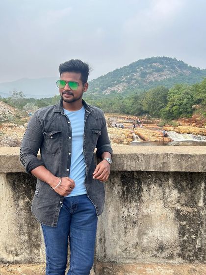 Posing against the backdrop of the hills and the river, capturing the essence of a nature trip.