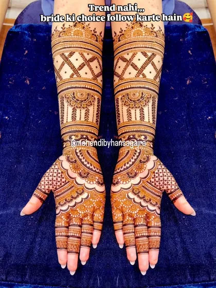 My philosophy is simple: I follow my bride's choice, not trends. This design is for the bride who loves elegance, with clean, symmetrical patterns on the arms and open palms for a look that is both royal and understated.