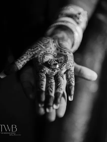 It's the little things that tell the biggest stories. This shot focuses on the union of two hands, the intricate mehndi, and the wedding ring that seals their promise. We believe these details are the beautiful footnotes in your love story.