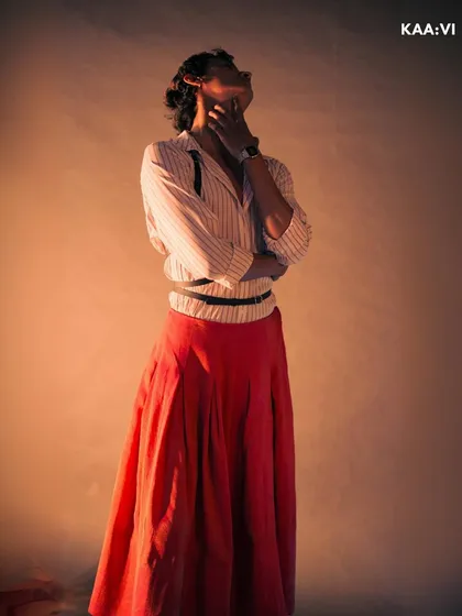 This shot from my creative styling series captures a moment of expressive movement. The flowing red skirt contrasts with the structured top, blending masculine and feminine elements.