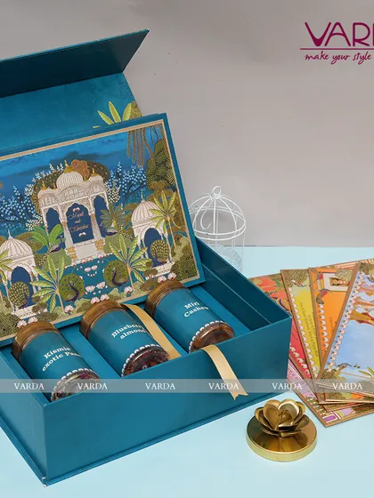 For a touch of artistic elegance, I designed this peacock-themed invitation box in a striking shade of blue. It includes gourmet jars and a suite of matching invitation cards, perfect for a sophisticated and vibrant wedding celebration.