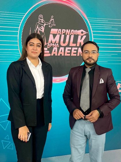 Posing with my co-host on the set of 'Apna Mulk Apna Aaeen'. We aim to demystify complex laws for our viewers.