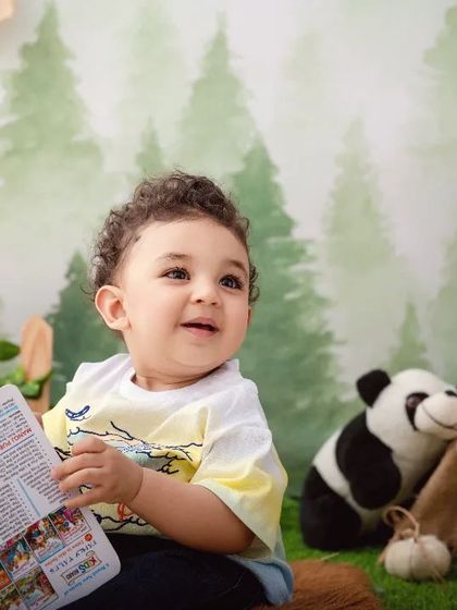 A moment of quiet reading in the middle of the jungle. This shot showcases the calm and curious side of your little explorer.