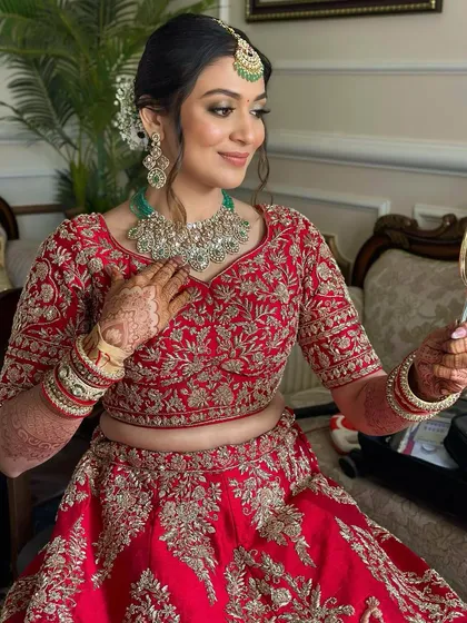 "I want to look like me, but on my wedding day." This bride is checking her reflection, happy with the soft glam look that feels enchanting yet true to herself.
