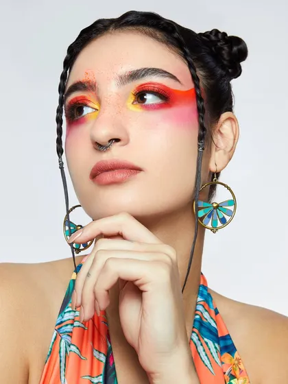 A vibrant tangerine dream. This look from a student's portfolio shoot features a beautiful blend of sunset colors on the eyes.