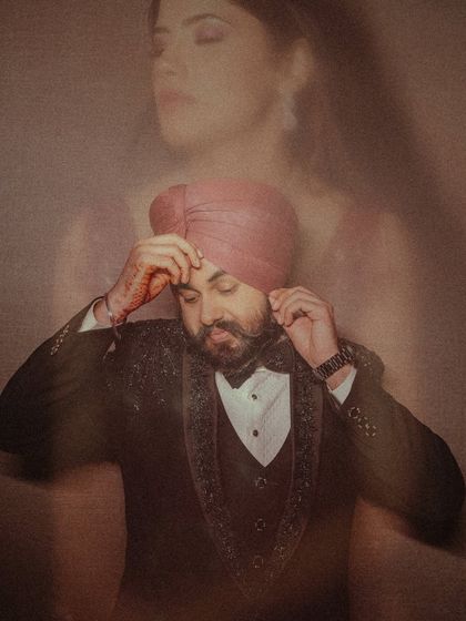 An artistic and moody portrait of the groom, Avikash. The double exposure effect with his bride's silhouette faintly visible adds a layer of romance and depth.
