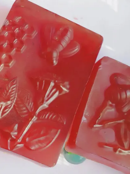 Another look at the detailed bee and flower designs on my red herbal soaps. Art and nature combined for your skincare.
