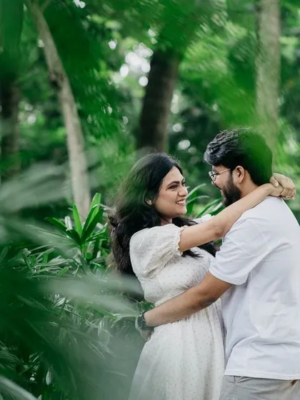 A duplicate of image 91, capturing an intimate and loving embrace surrounded by the lush greenery of a Bangalore park.
