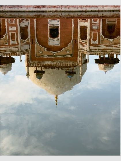 The reflection of Humayun's Tomb in the water, turned upside down to create a surreal and artistic image.