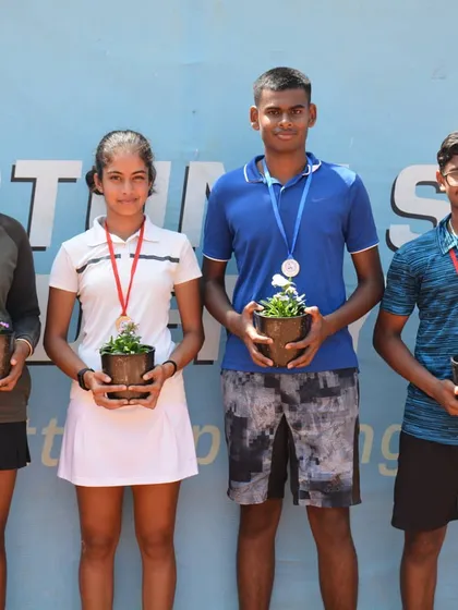 The winners and runners-up of the AITA CS 3 U18 tournament proudly display their medals and eco-friendly potted plant awards. We celebrate every achievement and encourage sustainability in sports.