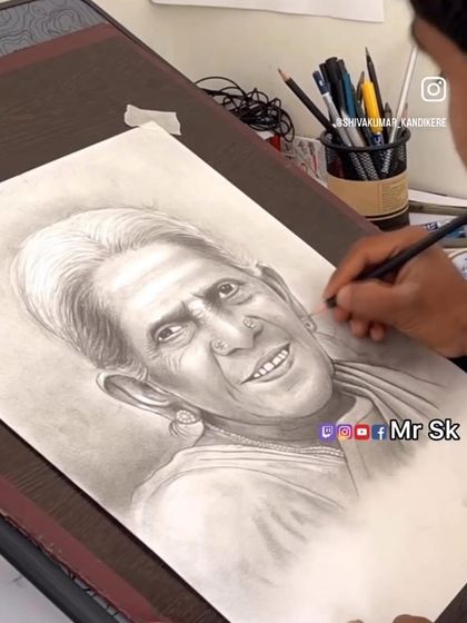 A video still showing me at my drawing board, working on a detailed portrait of Saalumarada Thimmakka.
