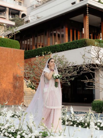 A candid moment of the bride's emotional and joyful reaction during her entrance at the Vogue wedding in Goa. This shot captures the real feelings behind the grand celebration.