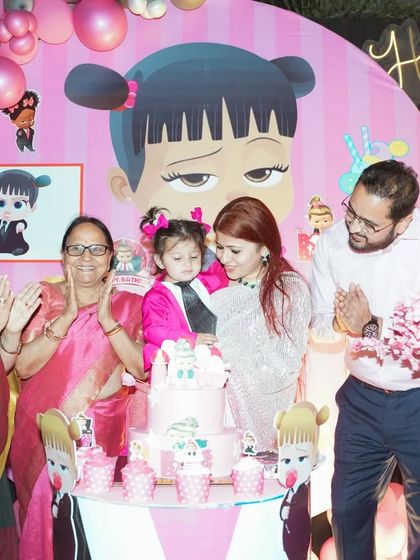 The whole family comes together for the cake cutting. We captured this joyful moment at Raavi's birthday, with three generations celebrating around the themed cake.