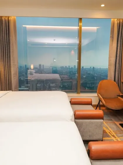 It's all about the mood. For this hotel bedroom, I shot at dusk to blend the warm interior lighting with the cool tones of the city skyline, creating an image that sells an experience, not just a room.