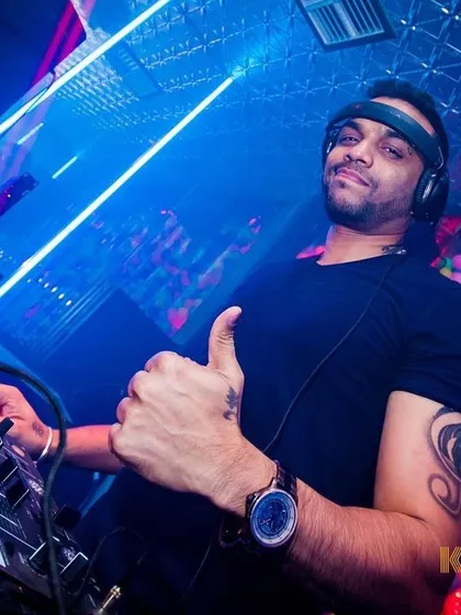 In the zone at Kandy Shop club, giving the crowd a thumbs up. I'm focused on reading the room and playing the right track at the right time, ensuring the energy stays high all night with a mix of Bollywood and R&B.