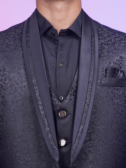 A close-up of the black jacquard tuxedo, focusing on the satin lapels and textured fabric. It's all in the details.