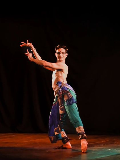 A classic Kuchipudi pose, showcasing the distinct posture and lines of the art form. This is a foundational stance from which many movements originate.