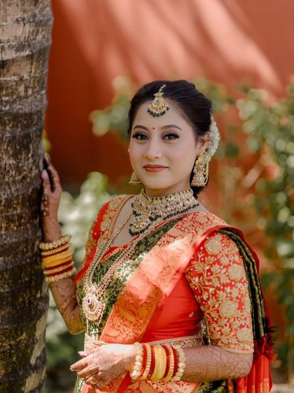 A beautiful South Indian bride wearing one of my temple jewellery sets. The choker, long necklace, and jhumkas perfectly match her traditional silk saree.