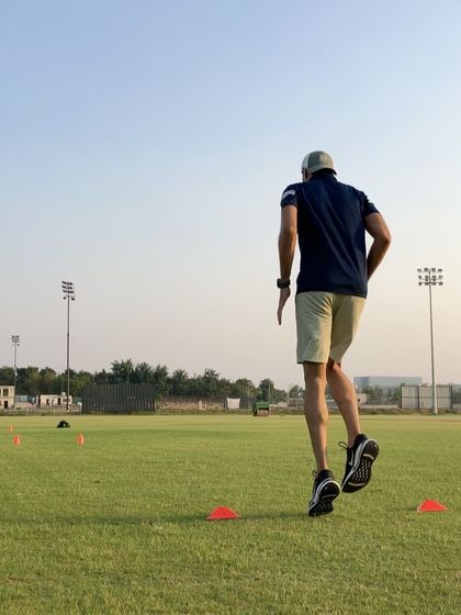 A bound in mid-air during a field drill. Bounding improves stride length and horizontal power, making you faster and more efficient when covering ground.