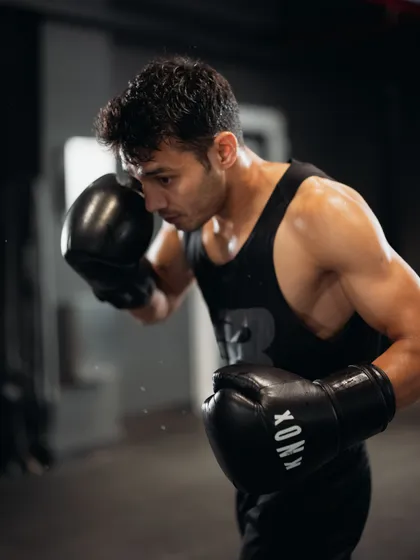 A boxer focuses on his shadowboxing technique, building muscle memory and sharpening his form. Every session is a step closer to a stronger you.