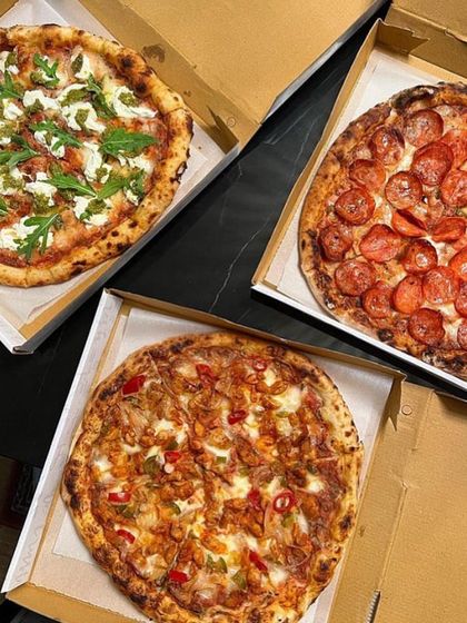 A trio of my Neapolitan beauties ready for delivery. This order includes a spicy chicken pizza, a classic pepperoni, and a vegetarian option with arugula and cheese.
