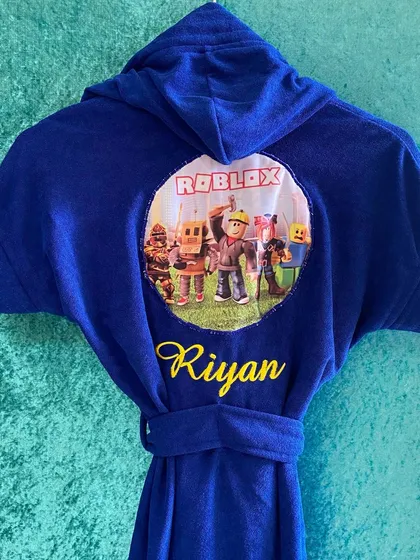 A blue version of our popular Roblox themed bathrobe, customised for 'Riyan'. It's a fun and practical gift for any kid.