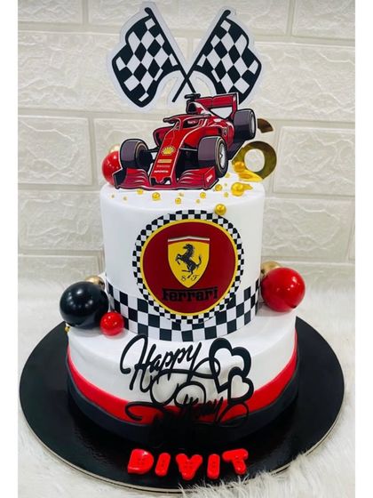 A high-octane Ferrari-themed cake for a racing fan. This two-tiered cake features the iconic logo, checkered flags, and a formula 1 car topper.