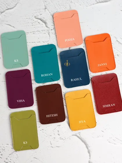 A collection of our personalized phone card holders, shown in 10+ different colors and customized with various names and initials.