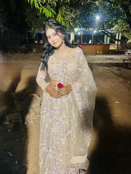 Another shot of the client in the beige and purple lehenga, holding a rose. A very romantic look for a reception or pre-wedding shoot.