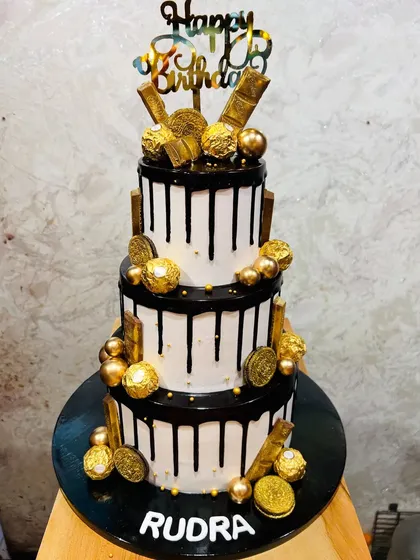 For the ultimate chocolate lover, this three-tier drip cake is pure indulgence. It's loaded with Ferrero Rocher chocolates, gold-dusted Oreos, and chocolate bars, making it a decadent choice for any birthday.