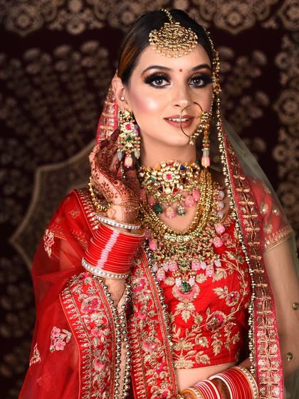 The complete look shows how a unique jewellery set can elevate a traditional red lehenga. Our wide rental collection offers endless possibilities.
