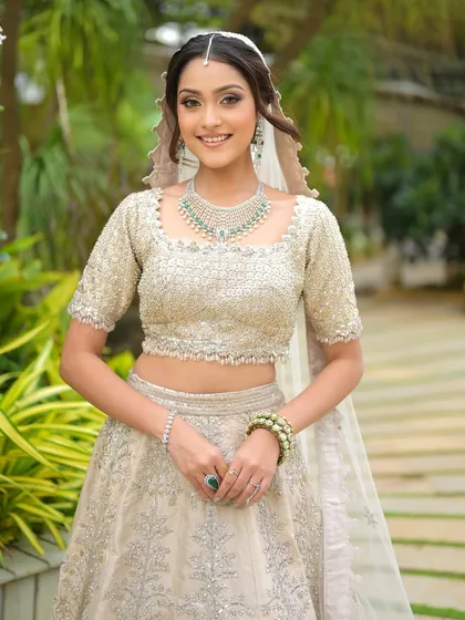 This bride is the picture of modern elegance. Her hair is styled in a simple, chic updo, and her makeup is soft and radiant, allowing her to shine.