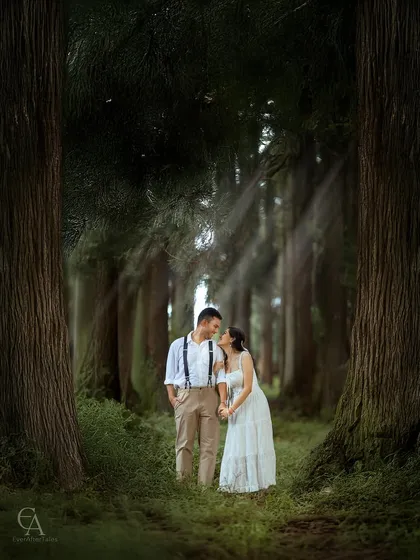 A quiet, shared glance between two people, framed by the immense scale of the ancient forest. This composition emphasizes their connection, making them the center of their own enchanting world.