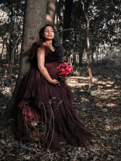 This dark, romantic ruffled gown is perfect for a moody and artistic maternity shoot in the forest. The rich color and texture of the tulle add a touch of drama.