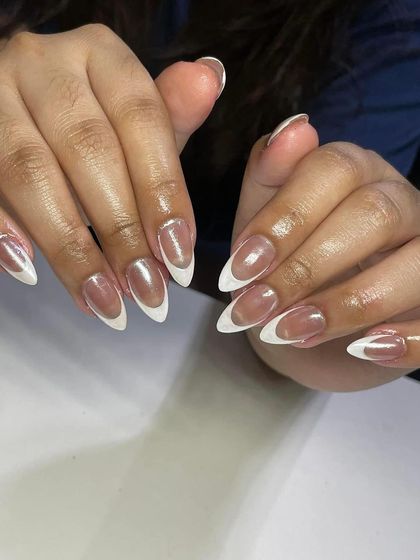 A classic French manicure with a chrome finish on the white tips, giving these almond-shaped nails a modern and reflective shine.