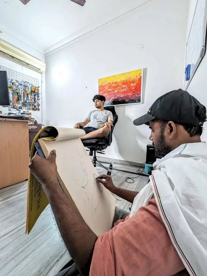 Another angle from our live sketching session. This shows how I observe the model from a distance to correctly capture proportions before starting the drawing.