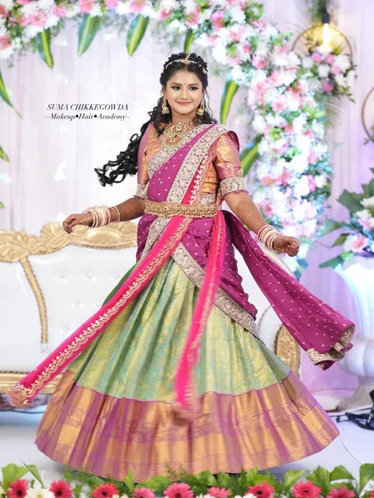 Half-saree functions are such a special milestone. For this young client, I created a fresh, age-appropriate look with bright colors and joyful energy, complete with elegant hairstyling to make her feel like a princess on her big day.